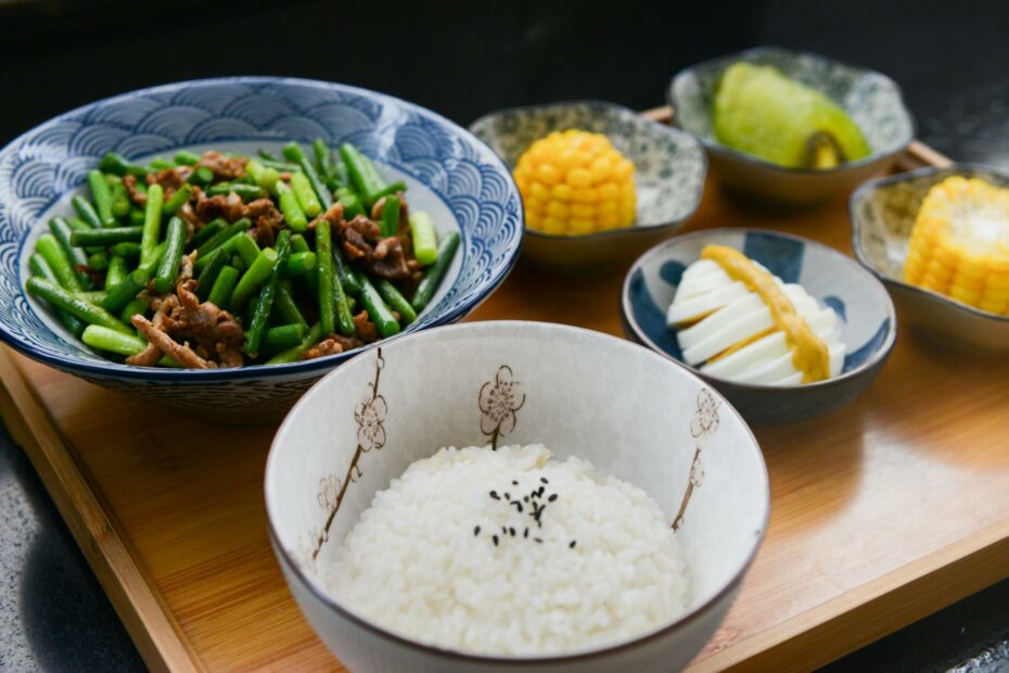 rice on bowl sliced egg corn and vegetable on table